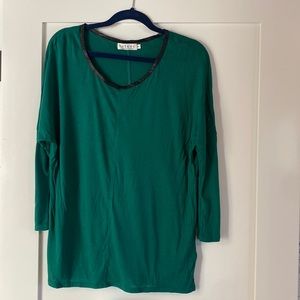 Forest green shirt with 3/4 length sleeve and leather trim on neckline